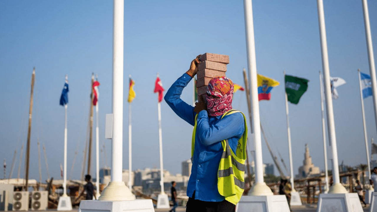 Worker carries bricks in Qatar. Credit: AFP Photo