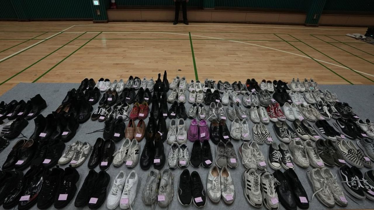 Shoes collected from the scene of a deadly accident following Saturday night's Halloween festivities, are placed at a temporary lost and found center at a gym in Seoul. Credit: AP/PTI Photo