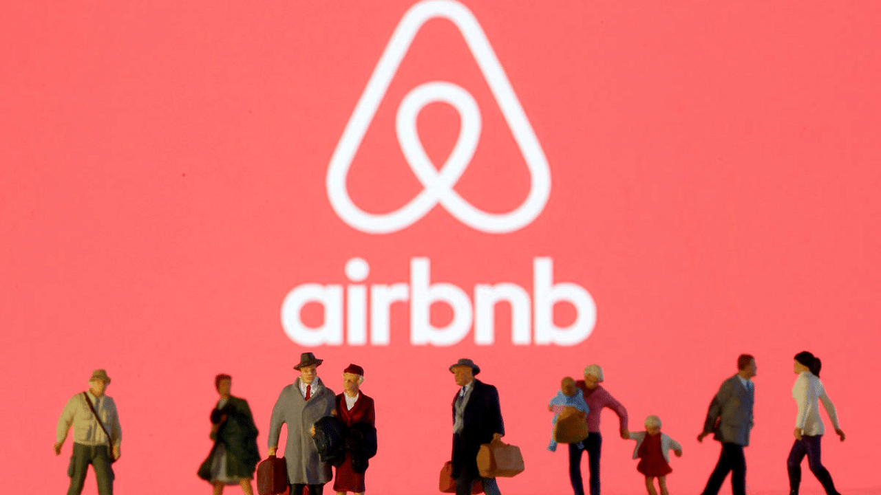 Toy figures in front of Airbnb logo. Credit: Reuters Photo