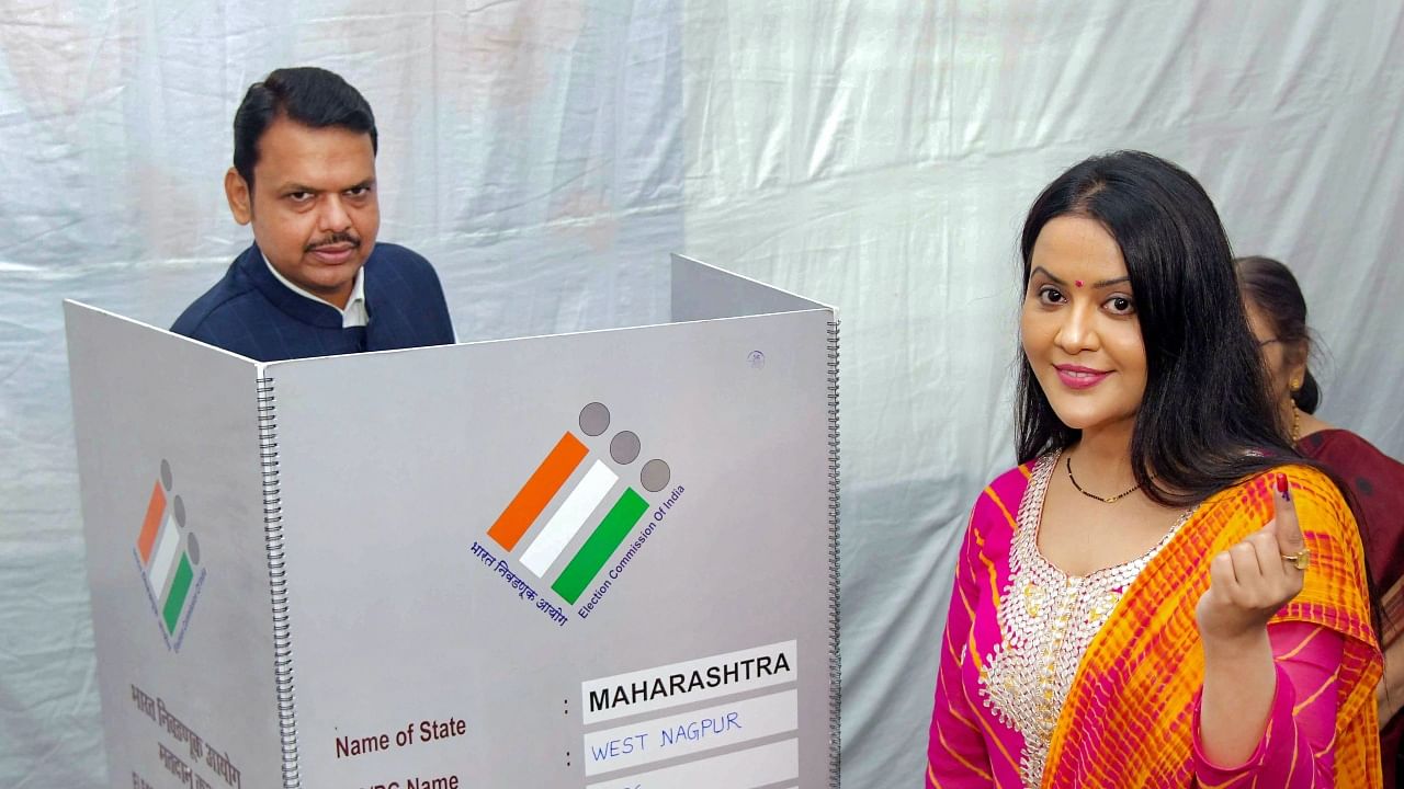 Maharashtra Dy CM Devendra Fadnavis (L) and wife Amruta Fadnavis (R). Credit: PTI File Photo