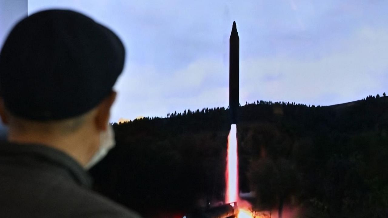 A man watches a television screen showing a news broadcast with file footage of a North Korean missile test, at a railway station in Seoul. Credit: AFP Photo