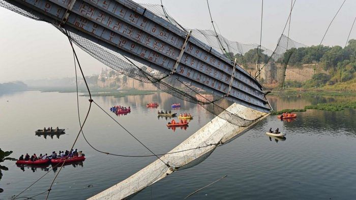 Rescue personnel conduct search operations after a bridge across the river Machchhu collapsed at Morbi. Credit: AFP Photo