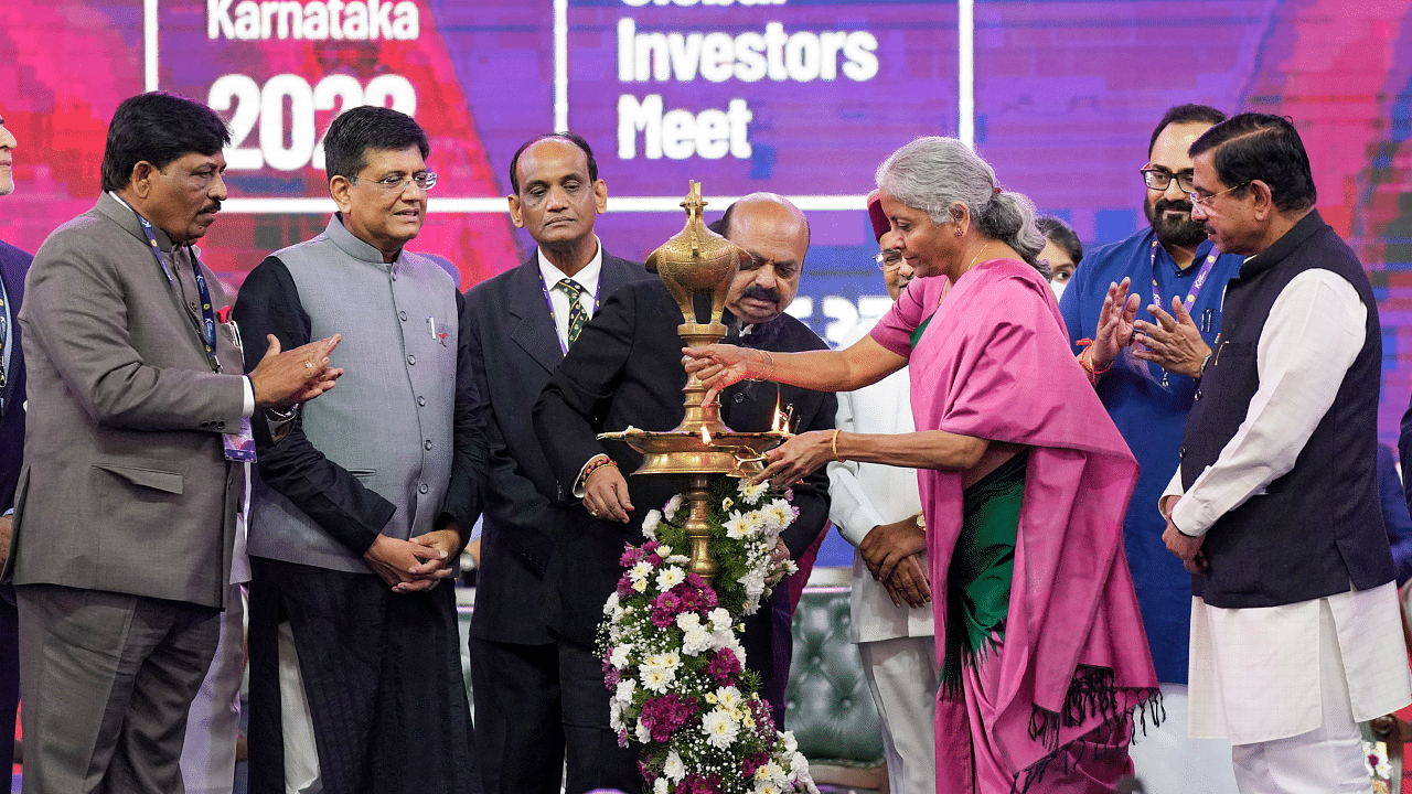 FM Nirmala Sitharaman with Karnataka CM Bommai lights a lamp during the inauguration of ‘Invest Karnataka 2022’. Credit: PTI Photo