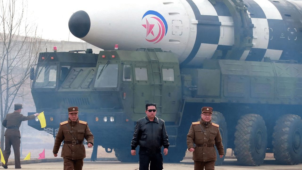 North Korea leader Kim Jong-Un walking near an ICBM. Credit: AFP photo/KCNA via KNS