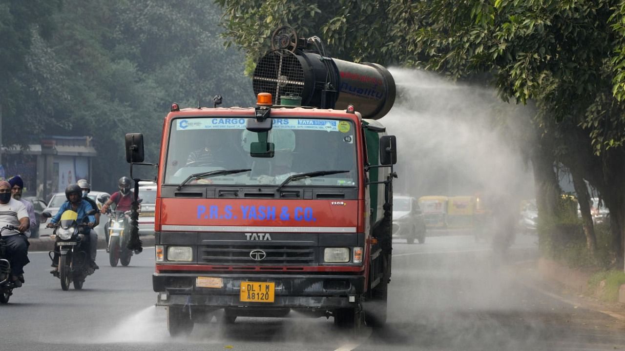 An anti smog gun fitted on a modified truck is used to spray water to curb pollution, in New Delhi. Credit: PTI Photo