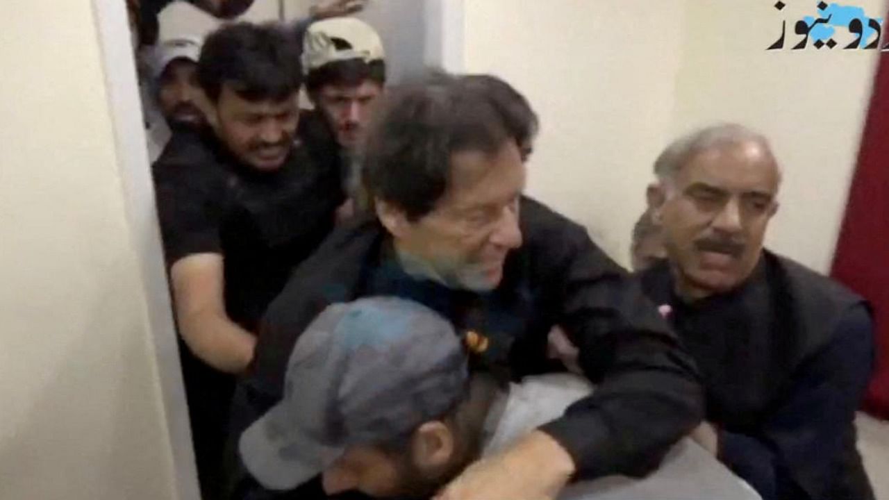Former Pak Prime Minister Imran Khan is helped after he was shot in the shin in Wazirabad, Pakistan. Credit: Reuters Photo