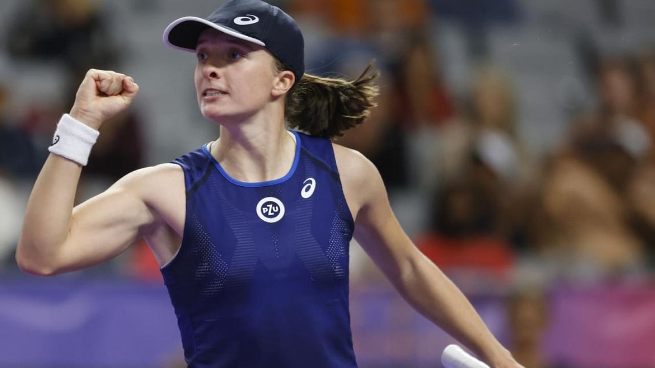 Iga Swiatek, of Poland, celebrates after winning her match against Caroline Garcia, of France, during round-robin play on day four of the WTA Finals. Credit: AP Photo