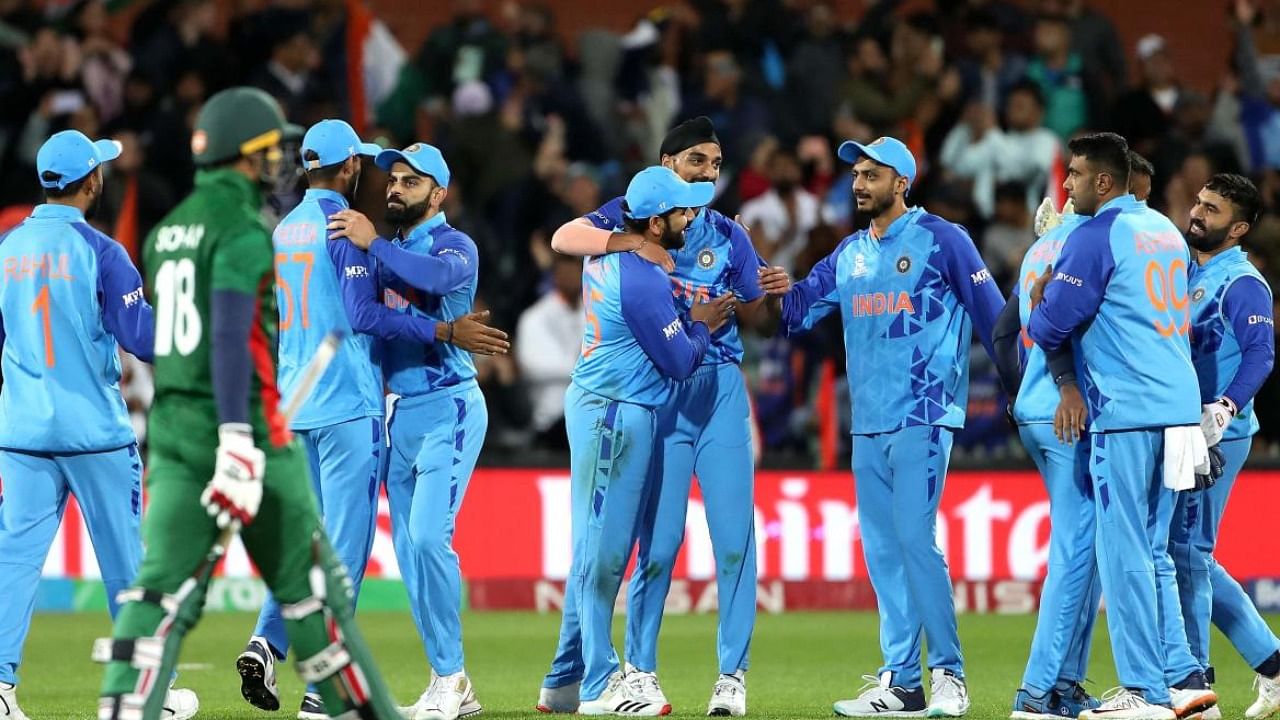 Team India celebrate their win in the T20 World Cup match against Bangladesh. Credit: AFP File Photo