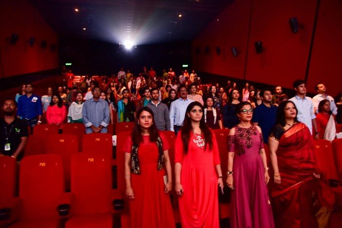 Audience at Vega City, Bannergatta Road, rise for the national anthem. Credit: DH Photo by B H Shivakumar