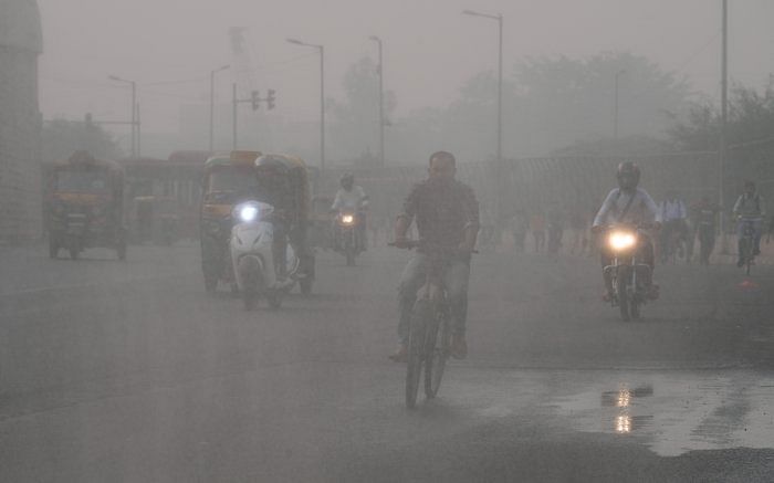 Vehicles ply on a road amid low visibility due to a thick layer of smog, in New Delhi. Credit: PTI Photo