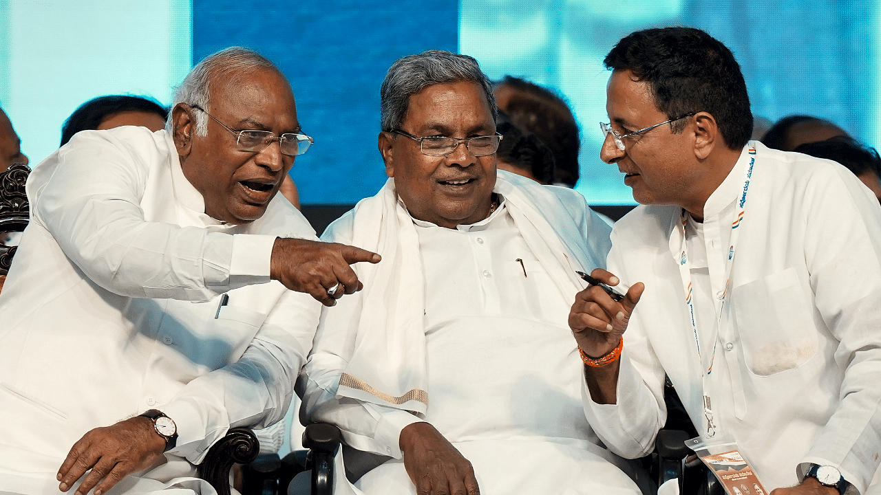 AICC President Mallikarjun Kharge with CLP leader Siddaramaiah and Randeep Singh Surjewala during a felicitation programme at Palace Grounds in Bengaluru. Credit: PTI Photo