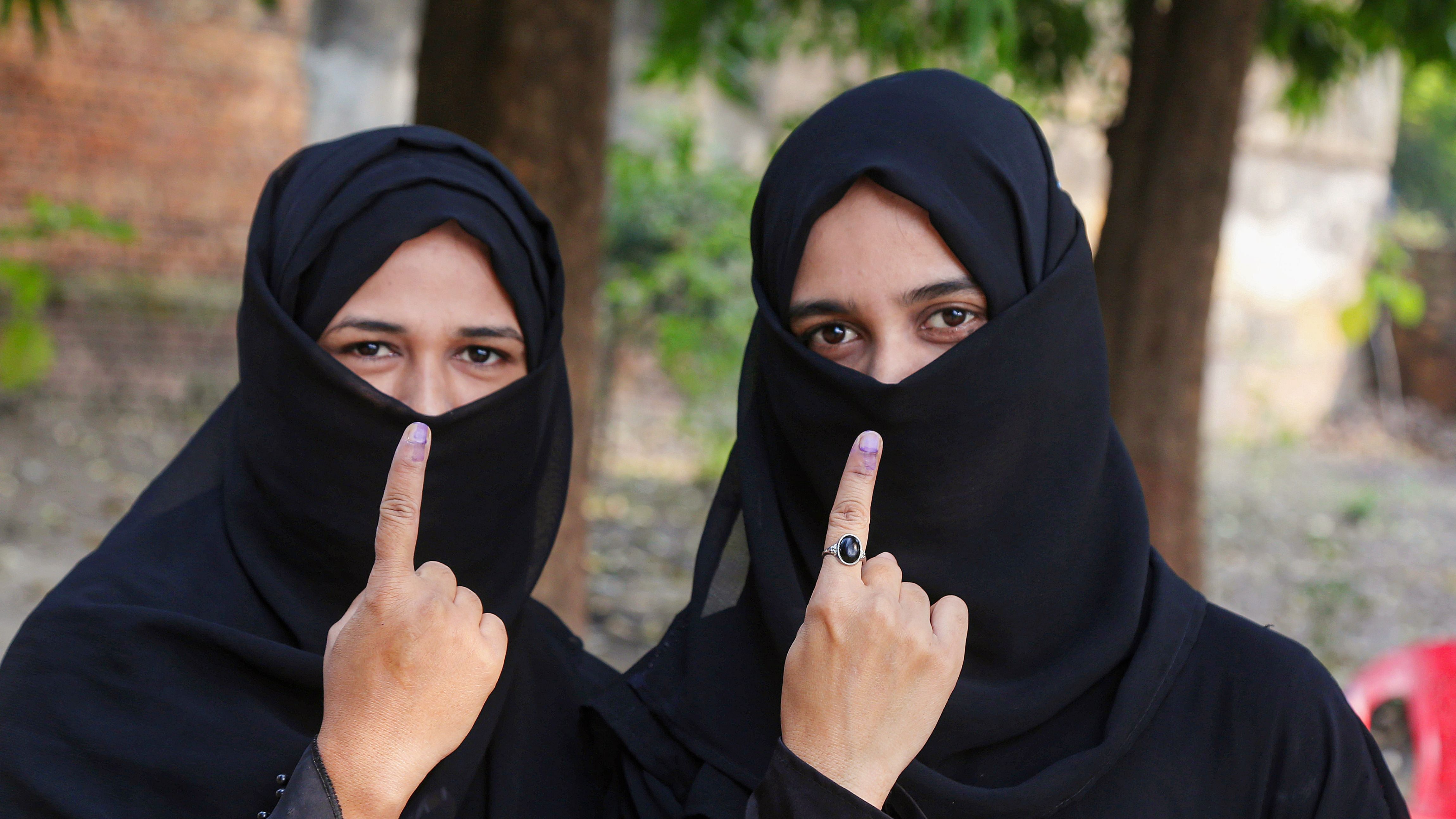 Voters show their ink-marked fingers after casting their votes in Uttar Pradesh's Gola Gokarannath constituency by-elections, in Lakhimpur, Thursday on November 3. Credit: PTI Photo