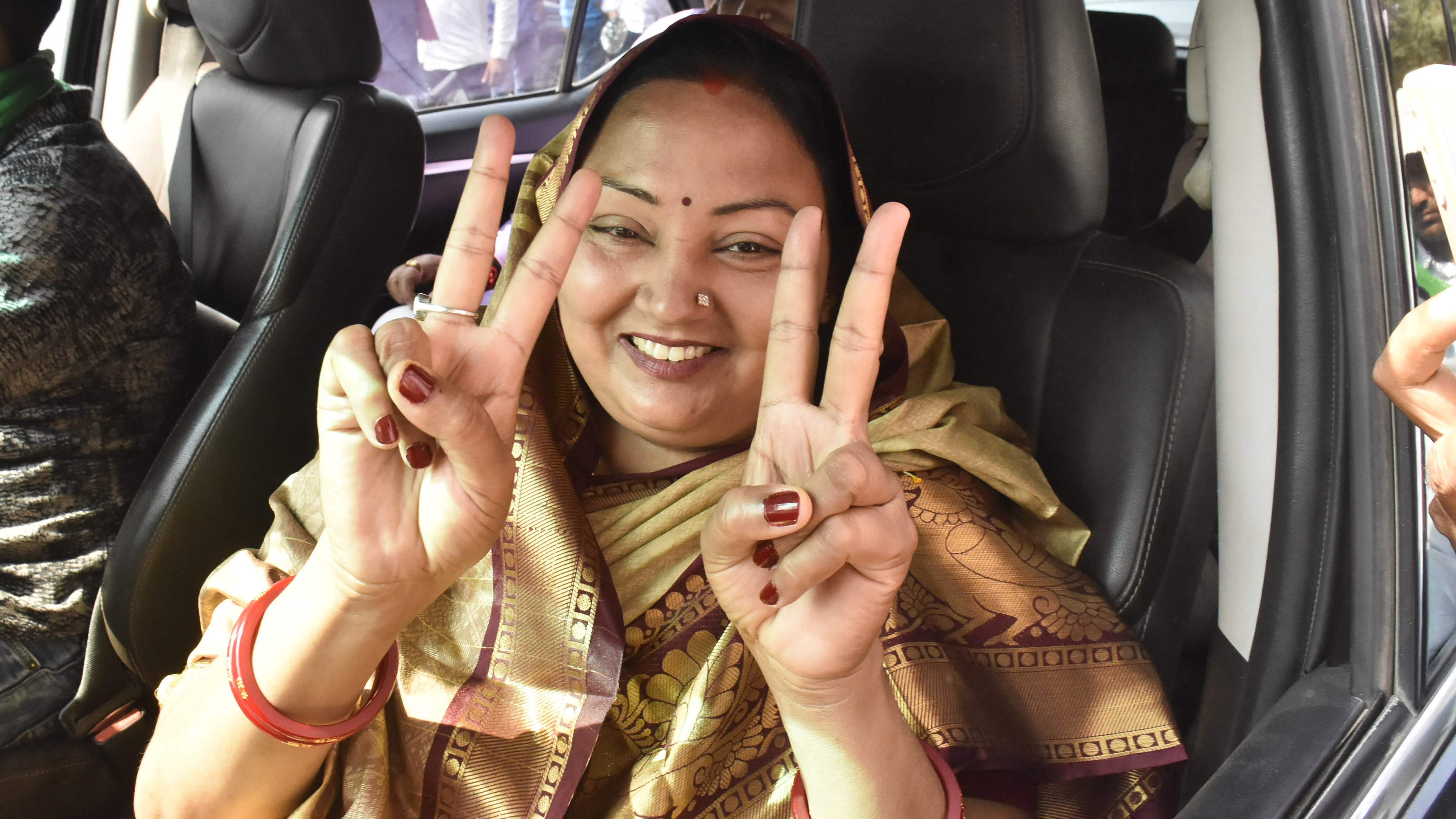 RJD candidate Neelam Devi flashes victory sign. Credit: PTI Photo