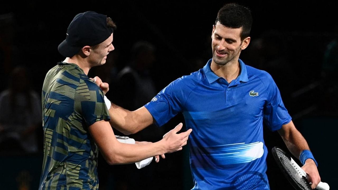 Denmark's Holger Rune (L) shakes hands with Serbia's Novak Djokovic after winning at the end of their men's singles final tennis match on day 7 of the ATP World Tour Masters 1000. Credit: AFP Photo