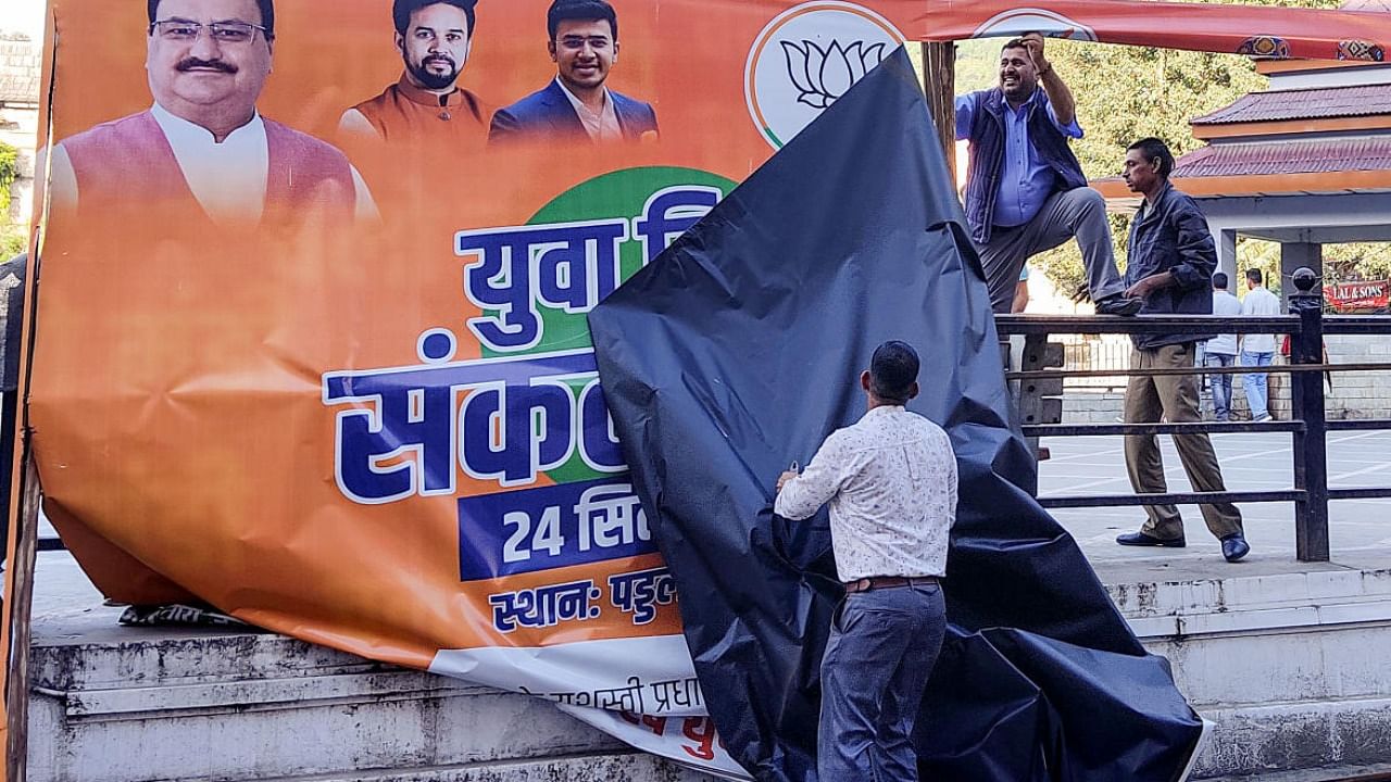 BJP workers with political party banners ahead of the upcoming Himachal Pradesh Assembly elections, in Mandi. Credit: PTI Photo