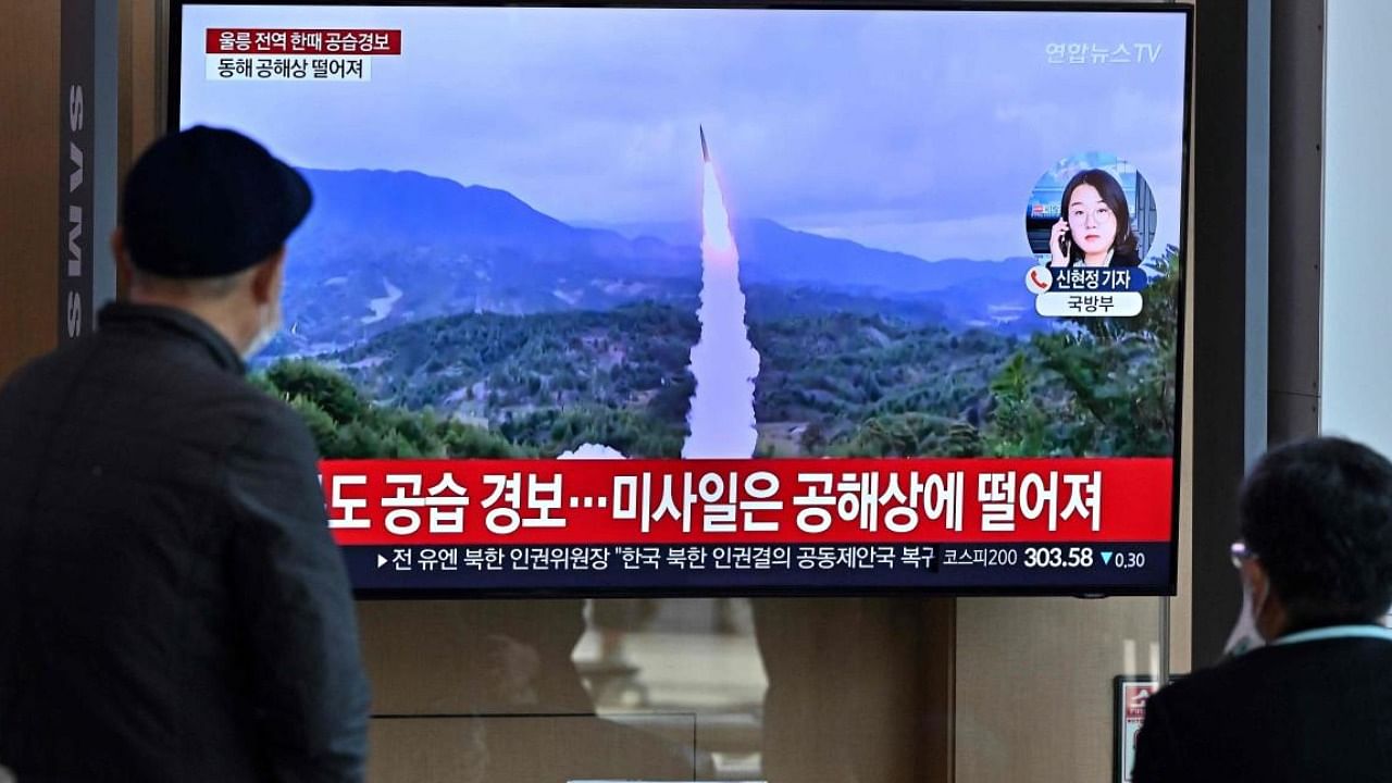 People in Seoul watch a TV showing a news broadcast with file footage of a North Korean missile test. Credit: AFP Photo 