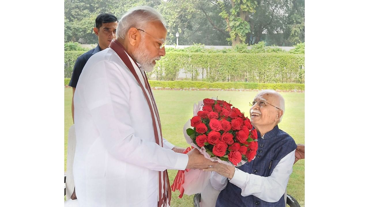 Modi meets Lal Krishna Advani on his birthday. Credit: PTI Photo