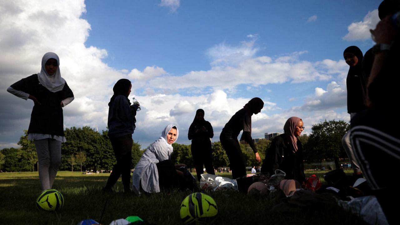Sisterhood FC team members take a break during a training session in Hyde Park, London. Credit: Reuters Photo