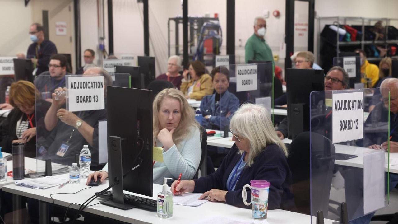 An adjudication board reviews ballots at the Maricopa County Tabulation and Election Center in Phoenix, Arizona. Credit: AFP Photo