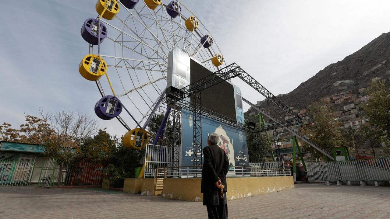 An Afghan man stands in an amusement park in Kabul, Afghanistan, November 9, 2022. Credit: Reuters Photo