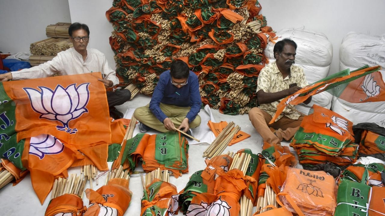 BJP party workers perpare flags ahead of campaigning for Gujarat polls. Credit: PTI Photo