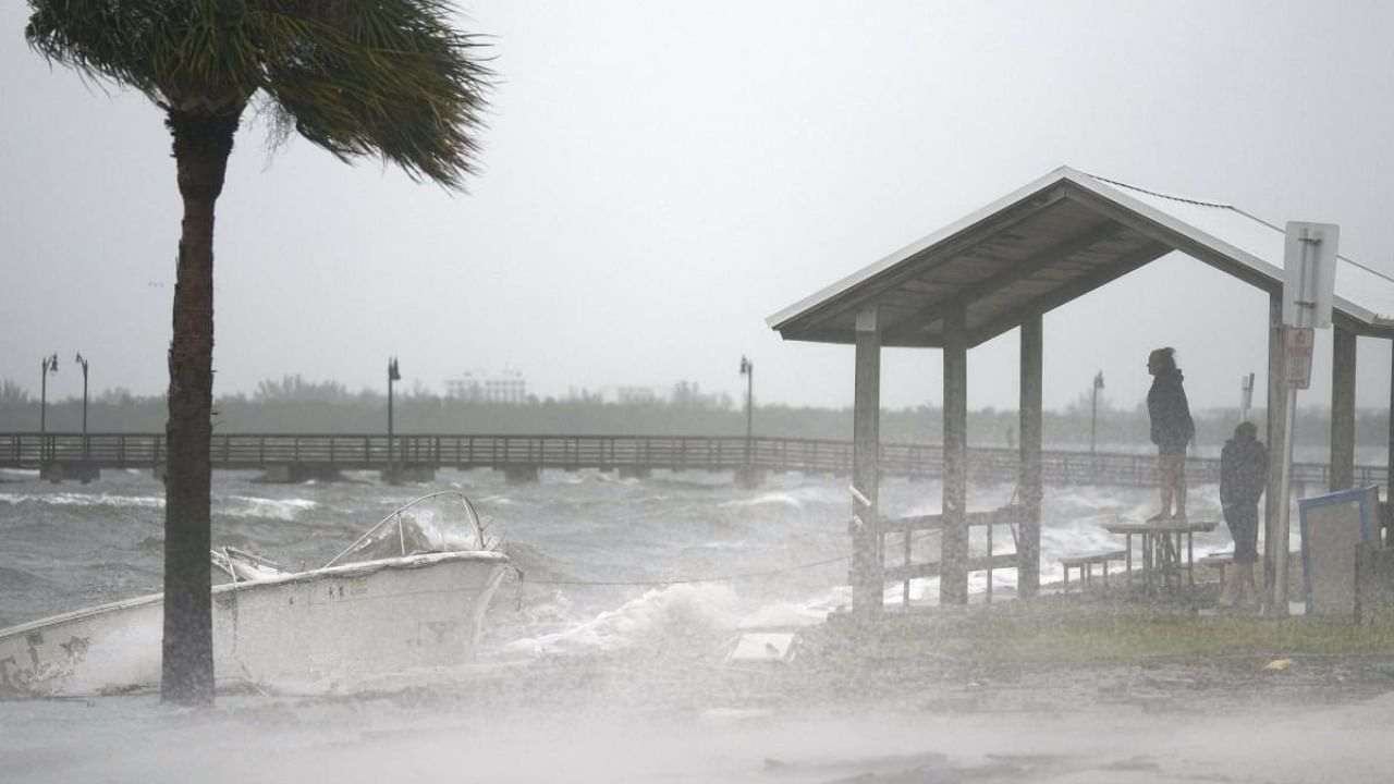 People brave rain and heavy winds to visit the waterfront along the Jensen Beach Causeway, as conditions deteriorate with the approach of Hurricane Nicole, Wednesday, November 9, 2022, in Jensen Beach, Florida. Credit: AP/PTI