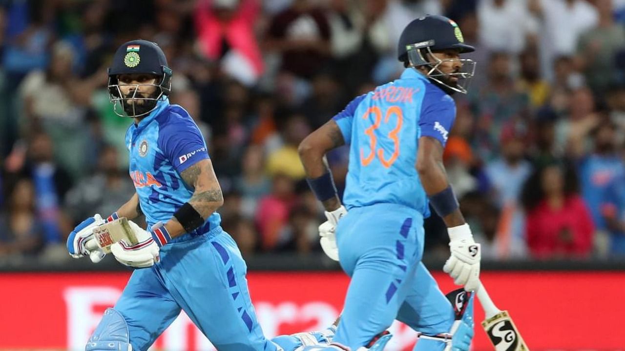  Virat Kohli (L) and Hardik Pandya run between the wickets during the ICC men's Twenty20 World Cup 2022 semi-final cricket match between England and India at The Adelaide Oval on November 10, 2022 in Adelaide. Credit: AFP Photo