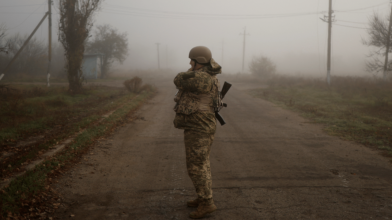 Ukrainian serviceman stands on a street in a village near Shihurivka. Credit: Reuters Photo
