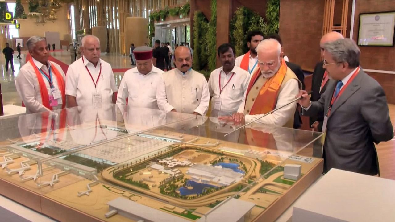 Prime Minister Narendra Modi looks at a model of the newly-inaugurated Terminal 2 of Kempegowda International Airport, in Bengaluru. Credit: PTI Photo
