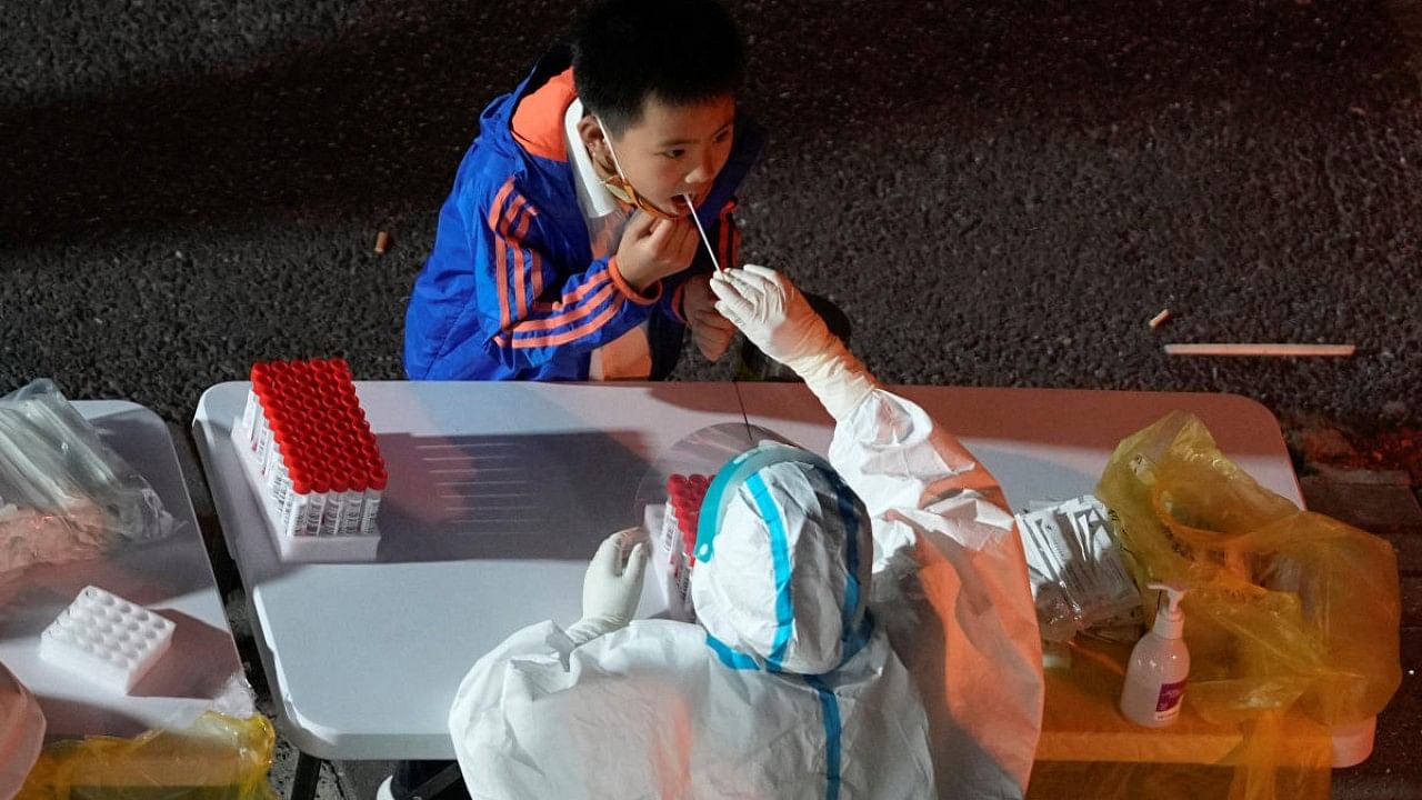 A boy gets tested for the Covid-19 at a nucleic acid testing site, following Covid-19 outbreak in Shanghai. Credit: Reuters Photo