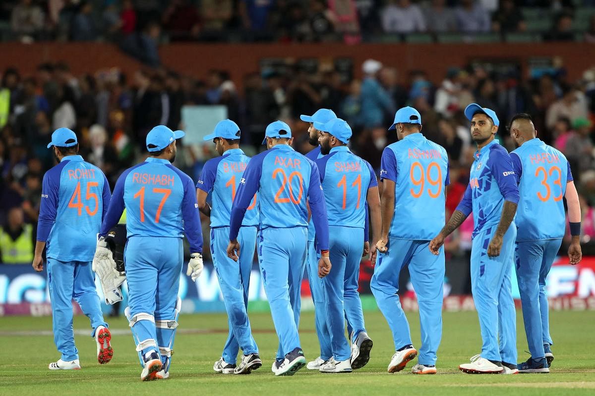Captain Rohit Sharma (L) escorts his team off the field after their loss during the ICC men's Twenty20 World Cup 2022 semi-final. Credit: AFP Photo
