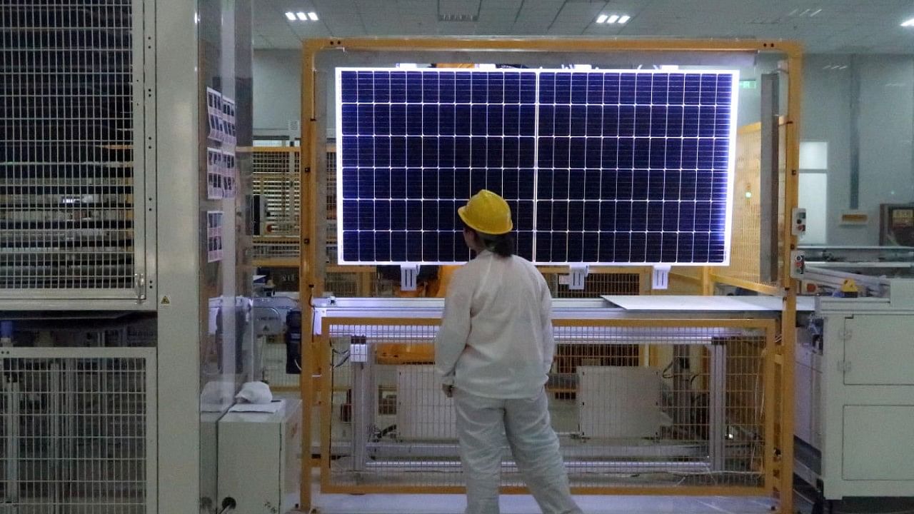 Worker conducts quality-check of a solar module product at a factory of a monocrystalline silicon solar equipment manufacturer in Xian, Shaanxi. Credit: Reuters File Photo