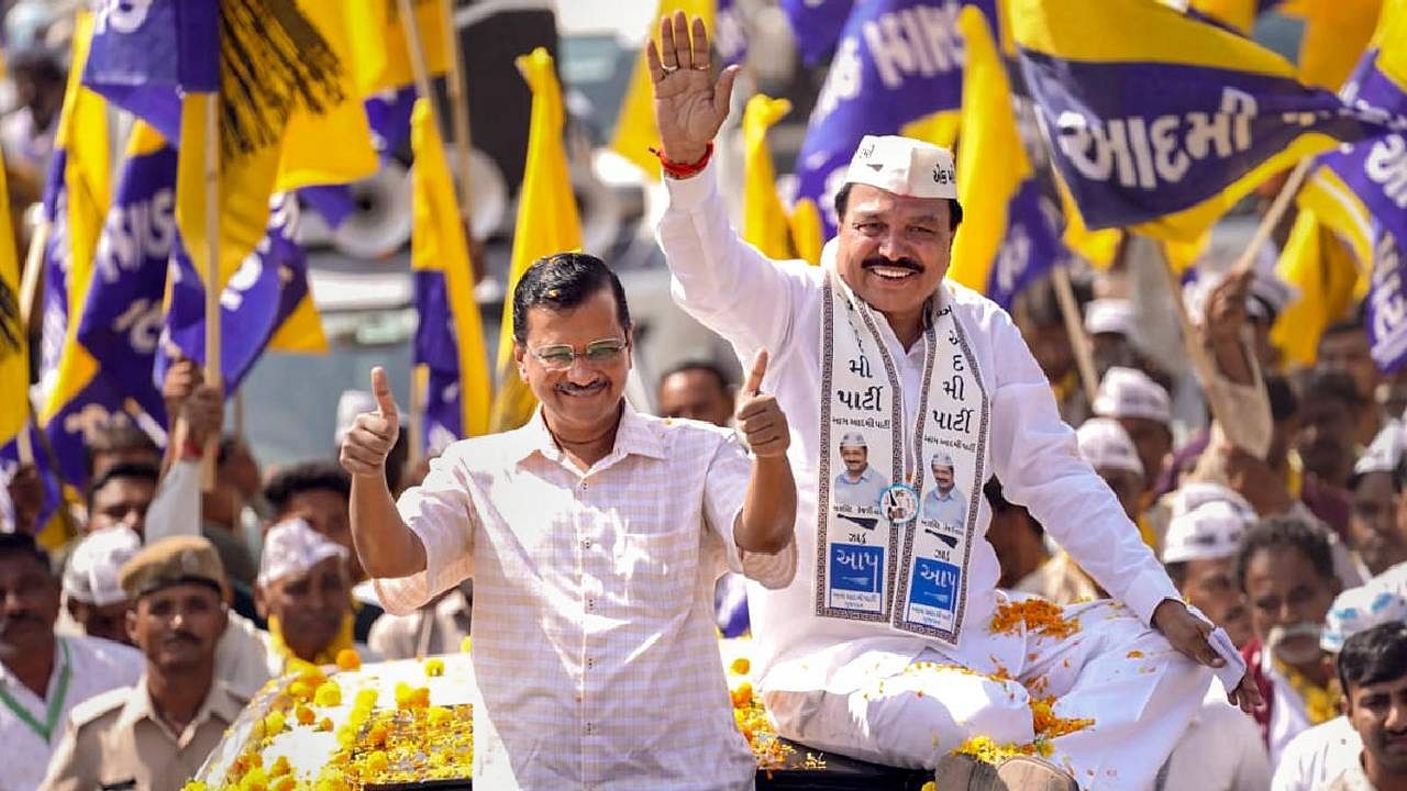 Aam Aadmi Party National Coordinator and Delhi CM Arvind Kejriwal participates in a roadshow for upcoming Gujarat Assembly elections, in Rajkot district. Credit: PTI File Photo