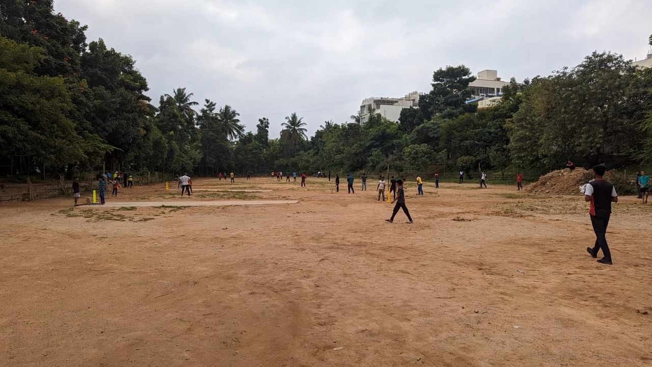 Officials inspect the playground in RR Nagar's BEML layout where the school will be built. Credit: DH Photo