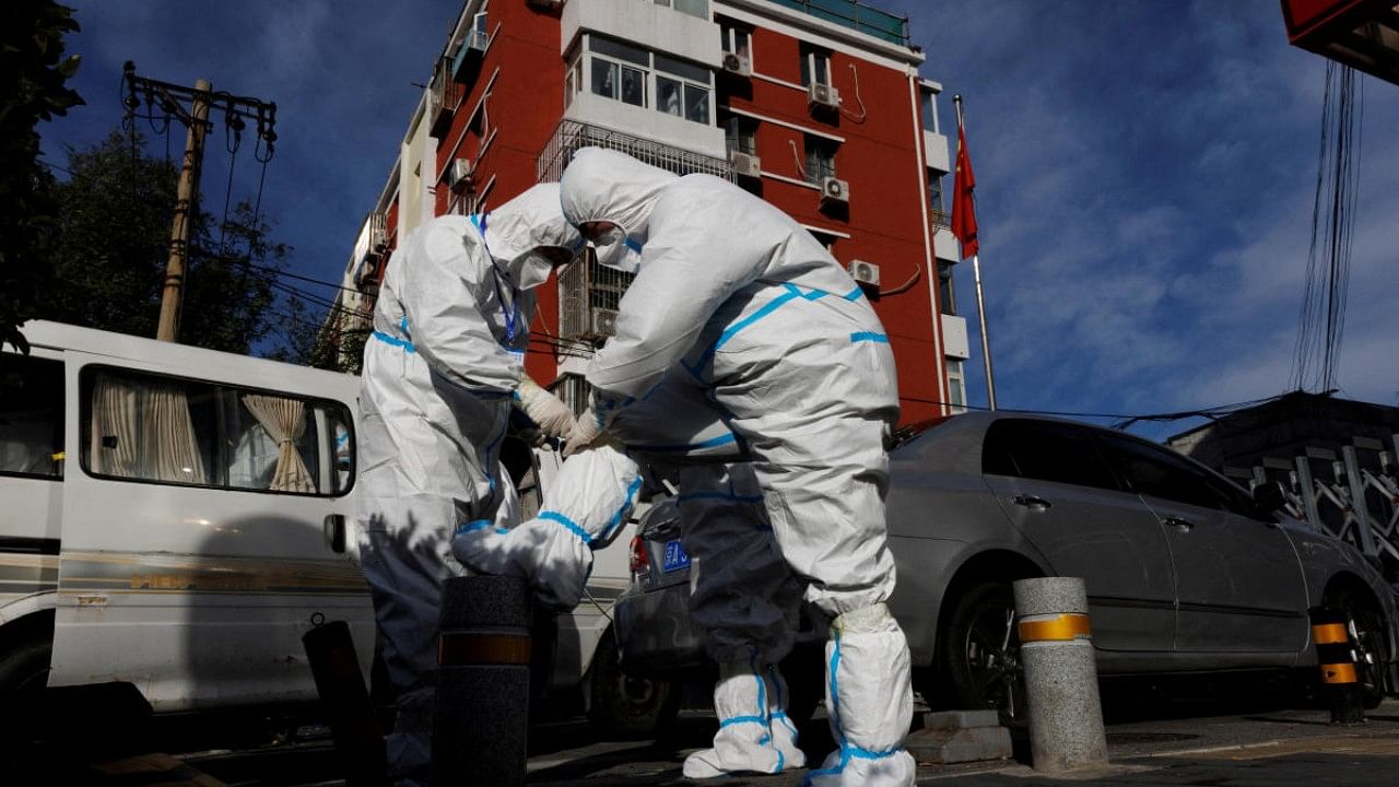 Pandemic prevention workers in protective suits prepare to enter an apartment compound that was placed under lockdown as outbreaks of the coronavirus disease continue in Beijing. Credit: Reuters Photo