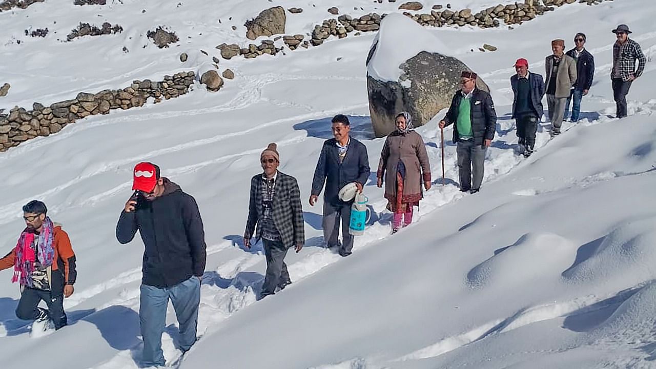 Voters wade through snow as they make way to their nearest polling station to cast their votes for the Himachal Pradesh Assembly elections, in the Bharmour Assembly constituency area. Credit: PTI Photo