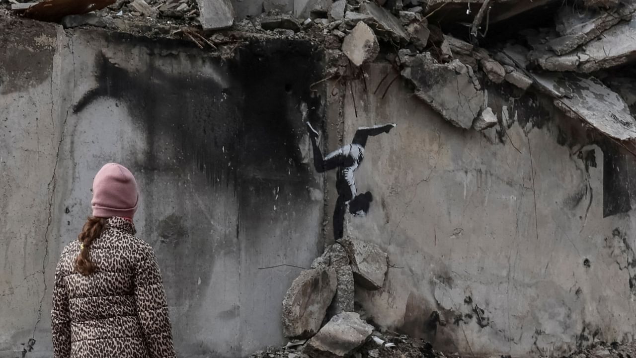 A work of world-renowned graffiti artist Banksy is seen at the wall of destroyed building in the Ukrainian town of Borodyanka, November 12, 2022. Credit: Reuters Photo