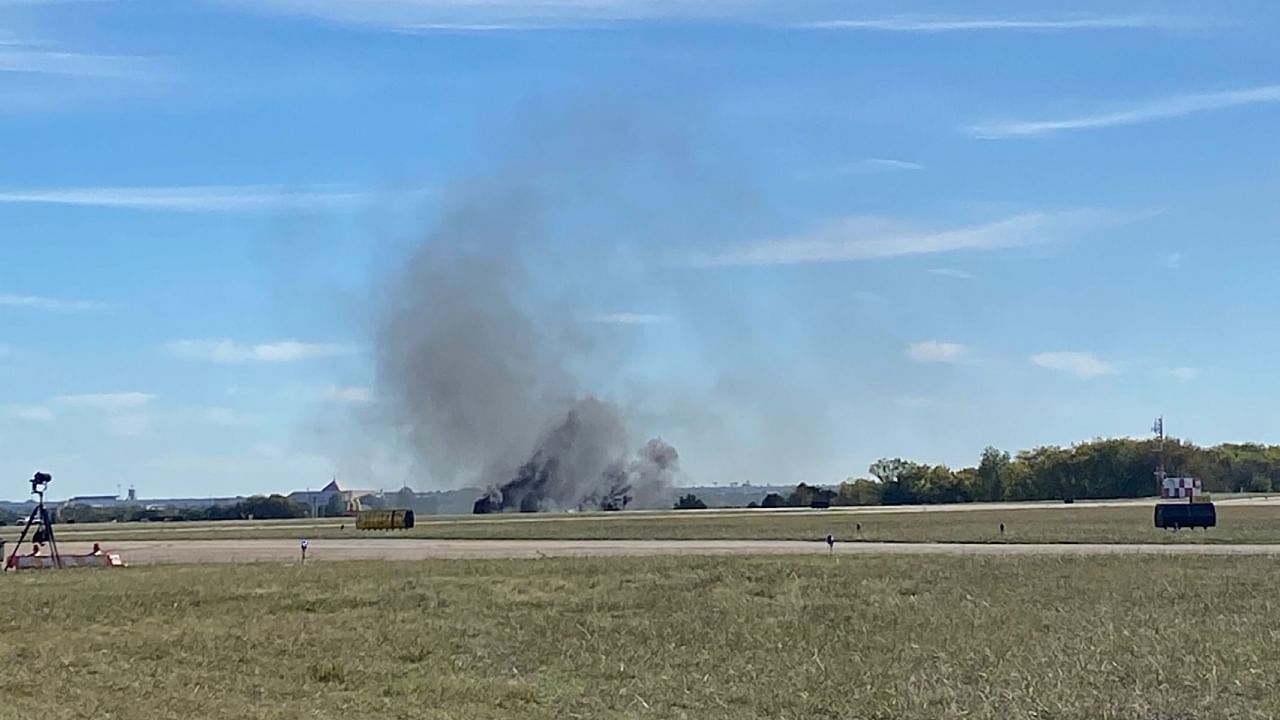 This image obtaimned from the twitter account @GollyItsMollie, shows smoke rising from the crash after two planes collided mid-air during the Wings Over Dallas Airshow at Dallas Executive Airport, in Dallas, Texas, on November 12, 2022. Credit: AFP Photo