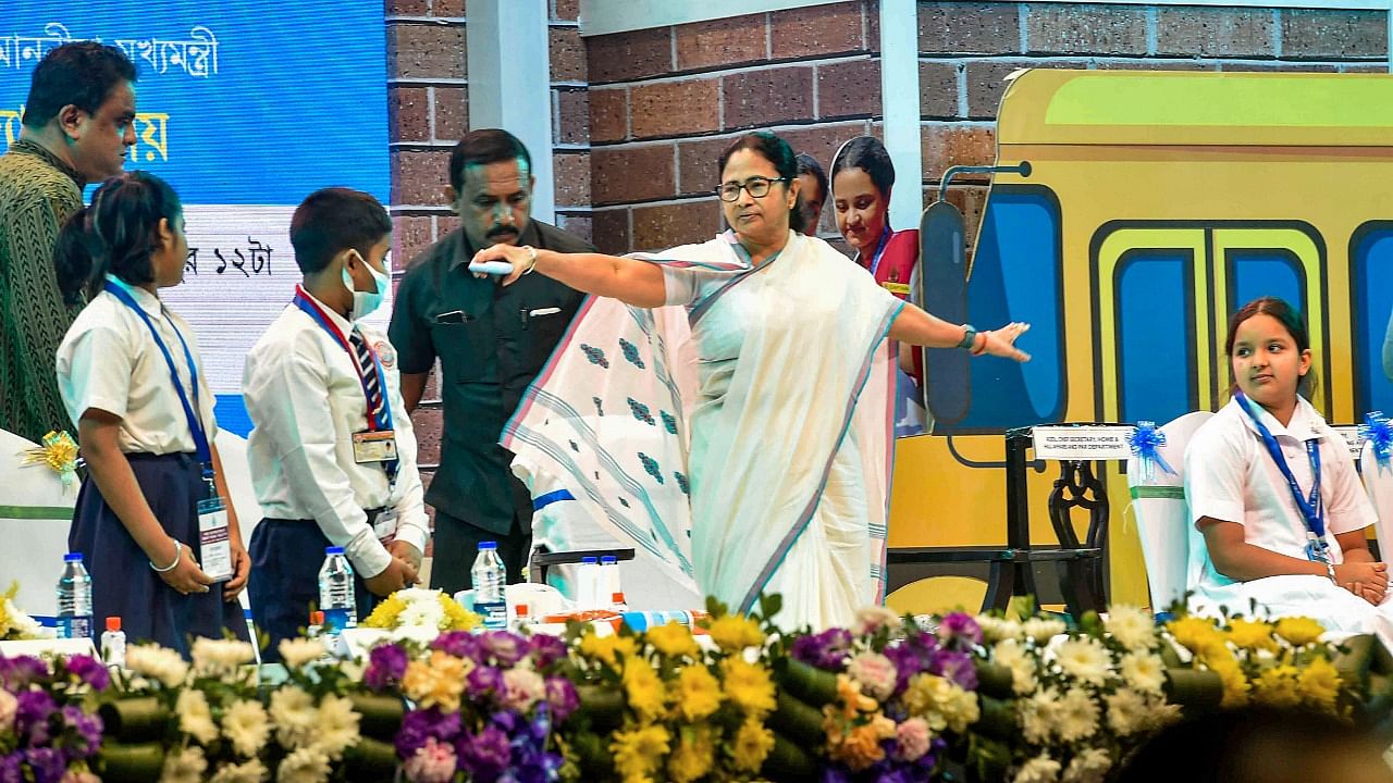 West Bengal Chief Minister Mamata Banerjee with school students during a programme under the state government's 'Taruner Swapna Scheme' on Children's Day, in Kolkata. Credit: PTI Photo