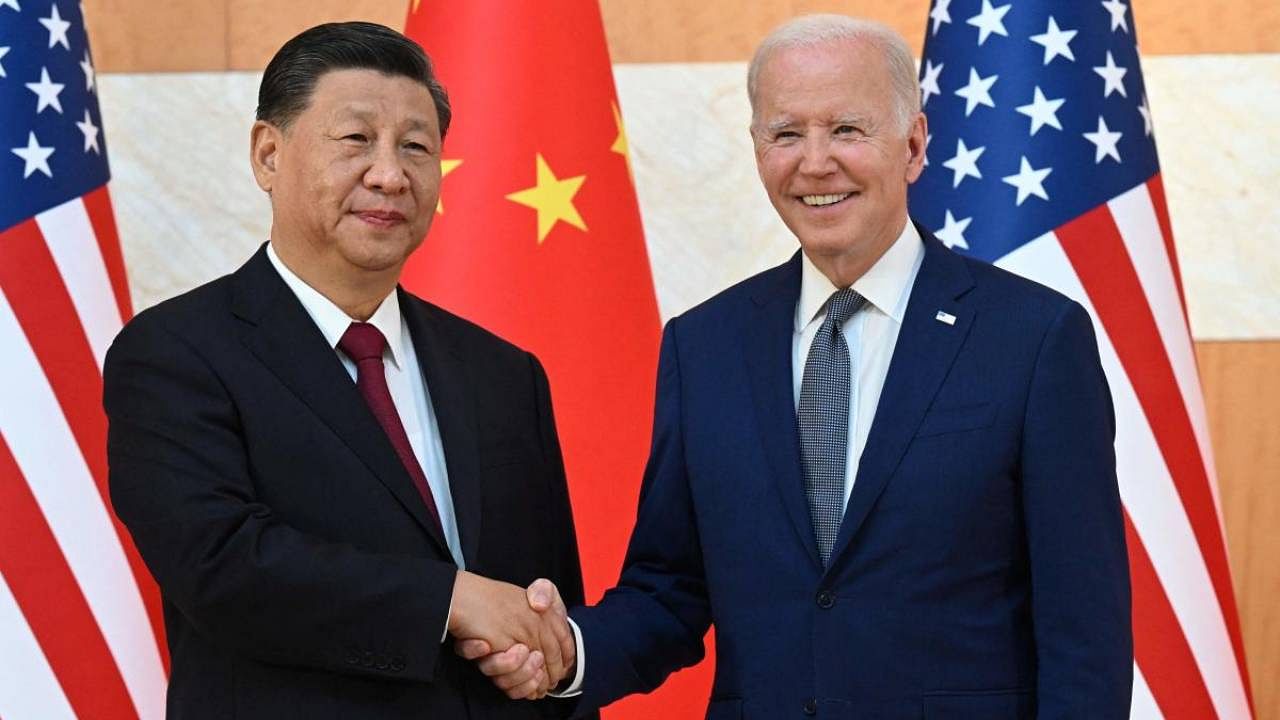 US President Joe Biden and China's President Xi Jinping shake hands as they meet on the sidelines of the G20 Summit. Credit: AFP Photo