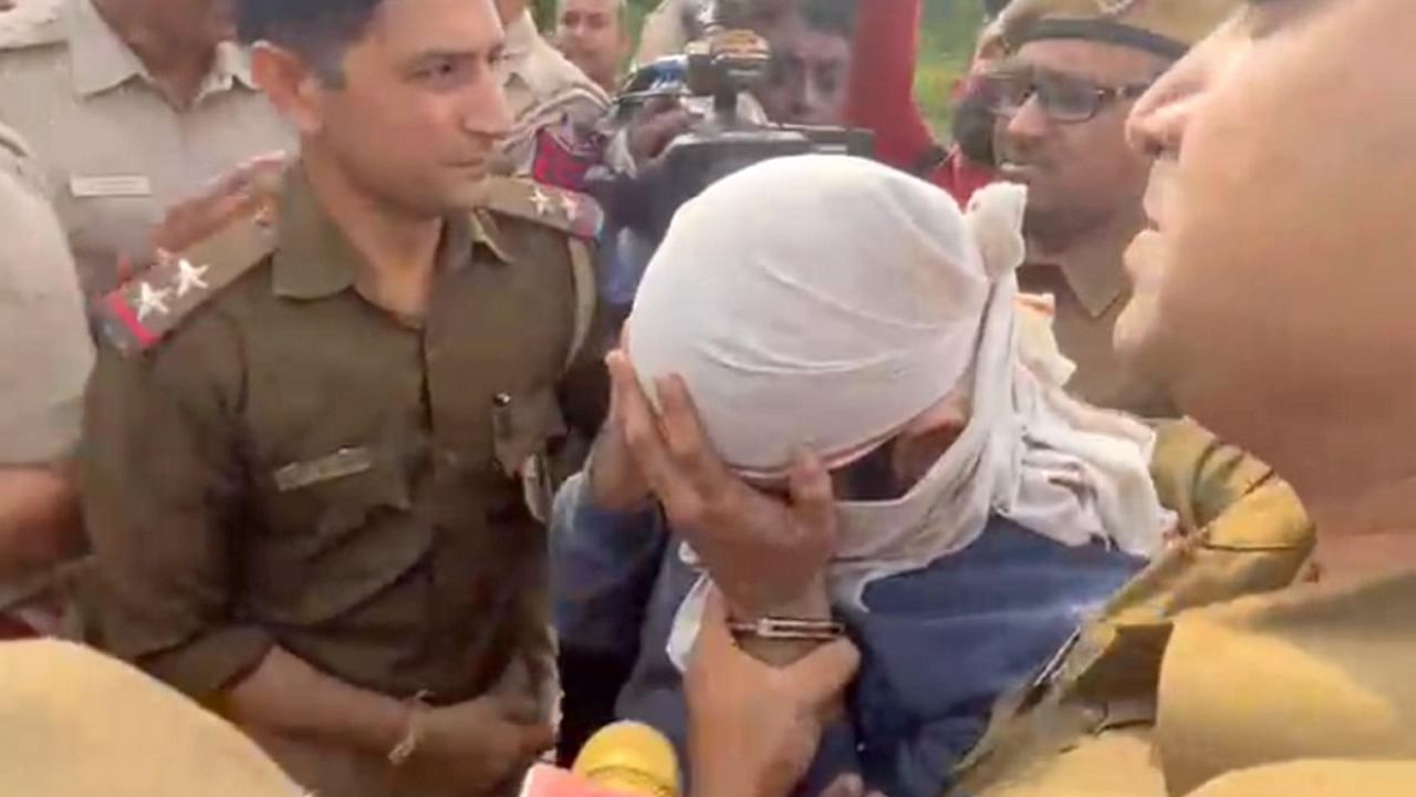 Aaftab Amin Poonawala, accused to have murdered his live-in partner Shraddha Walkar, being brought to the Mehrauli forest area, in New Delhi. Credit: PTI Photo