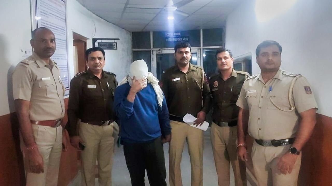 Police personnel along with accused Aftab Ameen Poonawala pose for the media, at Mehrauli Police Station. Photo: PTI Photo