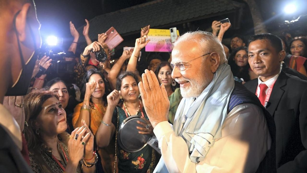 PM Narendra Modi being greeted by Indian community after arriving in Bali on Monday. Credit: PTI Photo