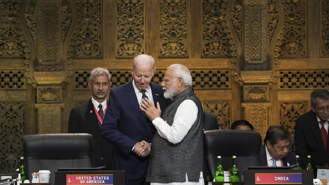 Indian PM Narendra Modi shakes hands with US President Joe Biden as India's Foreign Minister S Jaishankar watches during the first working session of the G20 leaders' summit. Credit: AP Photo