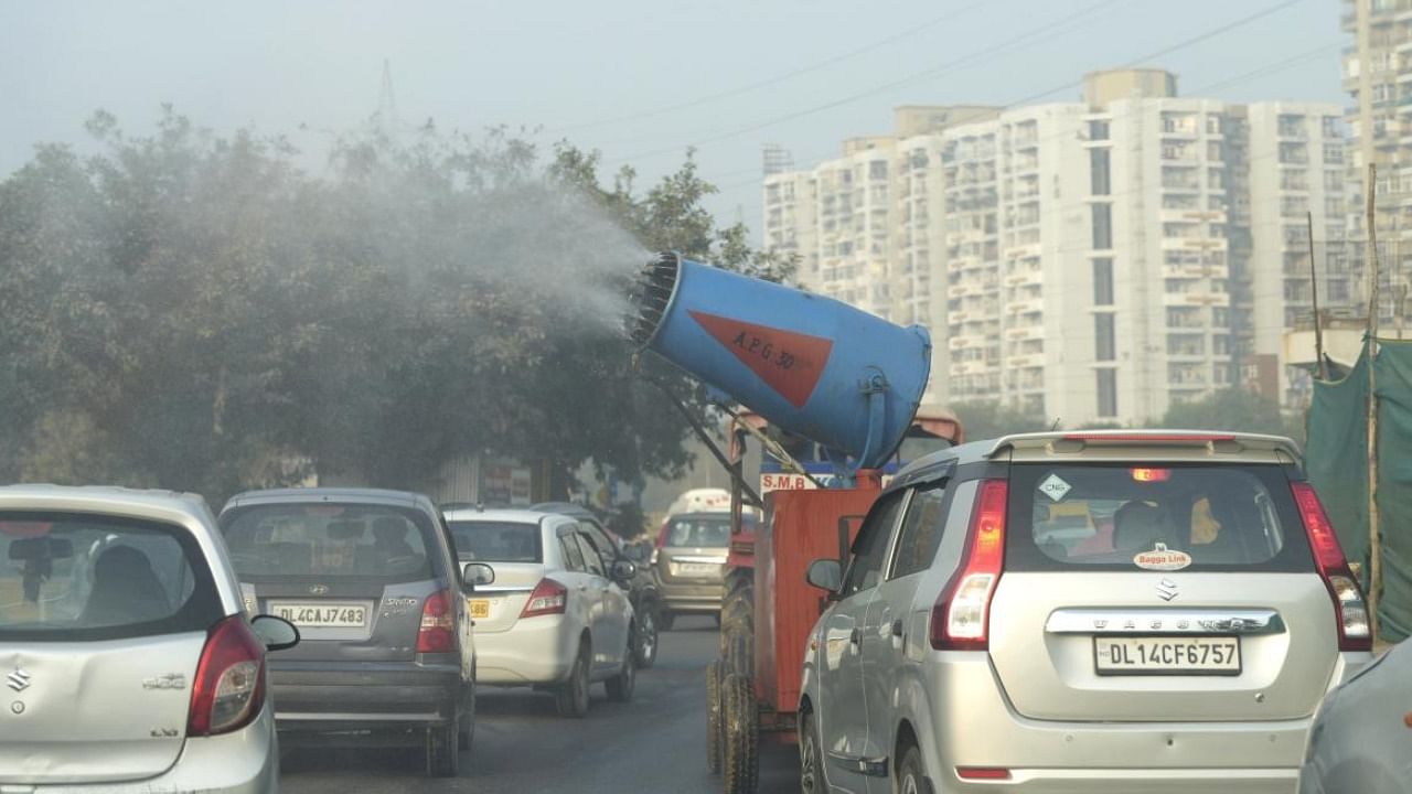 An anti-amog gun fitted on a modified vehicle is used to spray water to curb pollution, in New Delhi. Photo Credit: PTI Photo