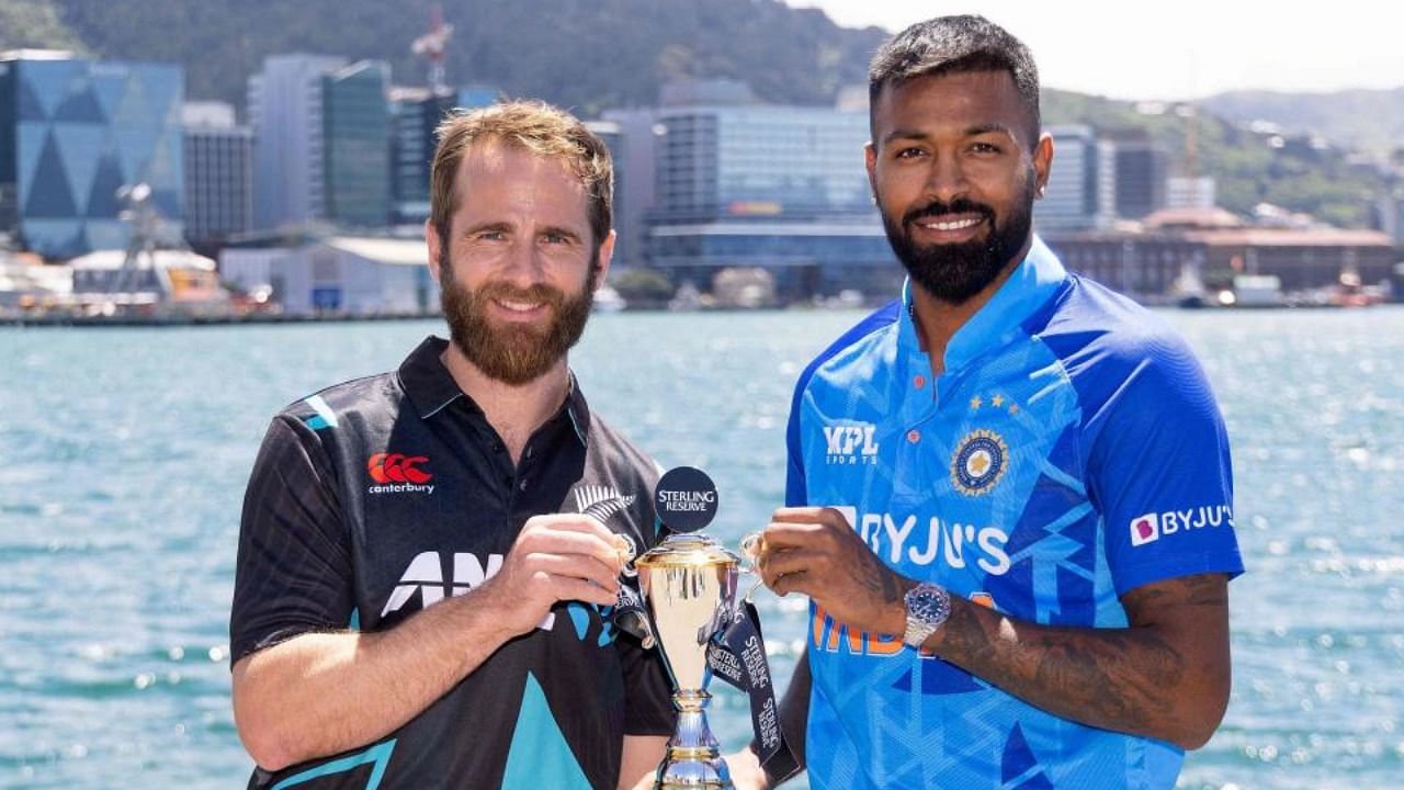 New Zealand captain Kane Williamson (L) and India captain Hardik Pandya (R) pose with the T20 trophy. Credit: AFP Photo
