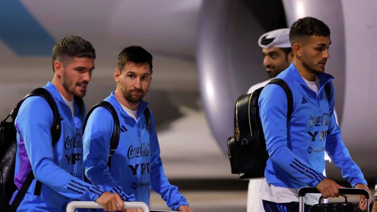 Argentina's forward Lionel Messi (C) and teammates arrive at the Hamad International Airport in Doha. Credit: AFP Photo