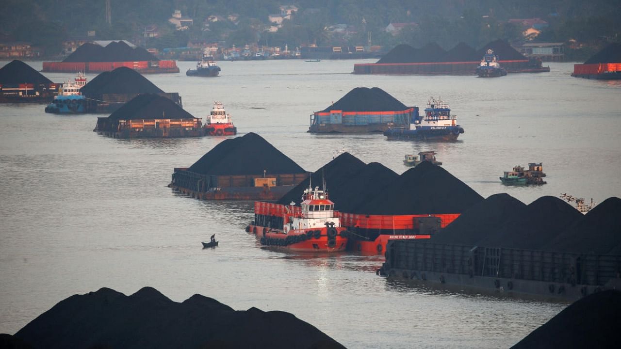 Coal barges are pictured as they queue to be pulled along Mahakam river in Samarinda, East Kalimantan province, Indonesia. Credit: Reuters photo