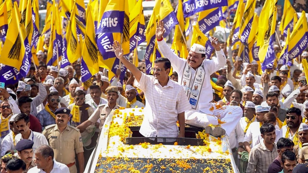 Aam Aadmi Party National Coordinator and Delhi Chief Minister Arvind Kejriwal participates in a roadshow in Rajkot. Credit: PTI Photo