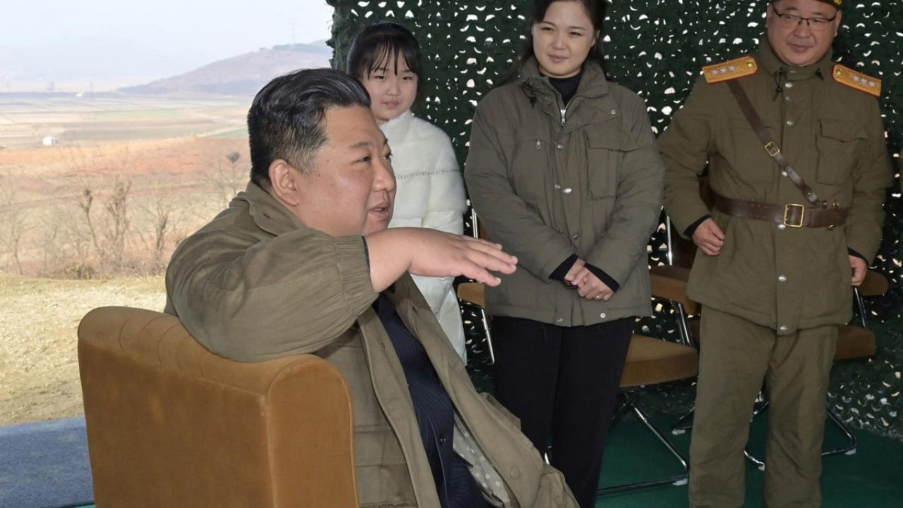 North Korean leader Kim Jong Un, with his wife Ri Sol Ju and their daughter, speaks on the day of the launch of an ICBM in this undated photo released by KCNA. Credit: Reuters Photo via KCNA